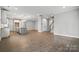 Spacious open-concept living area with wood floors and modern kitchen island at 9657 Liberty Hill Dr, Mint Hill, NC 28227
