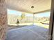 Covered patio area offers outdoor living with views of the wooded backyard at 9657 Liberty Hill Dr, Mint Hill, NC 28227