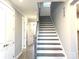 Beautiful staircase featuring modern design with luxury vinyl plank floors at 9657 Liberty Hill Dr, Mint Hill, NC 28227