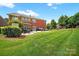 Charming backyard patio featuring an outdoor fireplace and comfortable seating at 103 Glenholden Ln, Mooresville, NC 28115
