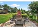 Charming backyard patio featuring an outdoor fireplace and comfortable seating at 103 Glenholden Ln, Mooresville, NC 28115