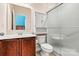 Cozy bathroom featuring a vanity, toilet, and shower with a frosted glass door at 103 Glenholden Ln, Mooresville, NC 28115