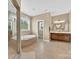 Bathroom with a large soaking tub, glass enclosed shower, and neutral tile flooring at 103 Glenholden Ln, Mooresville, NC 28115
