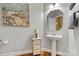 Stylish half bath features a pedestal sink, decorative mirror, and elegant lighting at 103 Glenholden Ln, Mooresville, NC 28115