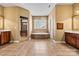 Bright bathroom featuring dual vanities, a soaking tub under a window, and a walk-in shower at 103 Glenholden Ln, Mooresville, NC 28115