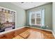 Bright bedroom featuring hardwood floors, a large window, and serene wall art at 103 Glenholden Ln, Mooresville, NC 28115