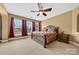 Bedroom with a ceiling fan, large window and a queen sized bed with a decorative headboard at 103 Glenholden Ln, Mooresville, NC 28115