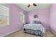 Bedroom with lavender walls, carpet, a ceiling fan, and a comfortable bed with soft bedding at 103 Glenholden Ln, Mooresville, NC 28115