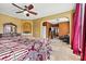 Primary bedroom with a fan, a large arched alcove, and windows with stylish red curtains at 103 Glenholden Ln, Mooresville, NC 28115