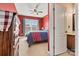 Bedroom featuring red walls, a ceiling fan, large windows, and beige carpet at 103 Glenholden Ln, Mooresville, NC 28115