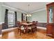 Elegant dining room featuring hardwood floors, detailed trim, and ample natural light at 103 Glenholden Ln, Mooresville, NC 28115