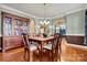 Bright dining room featuring hardwood floors, crown molding, and elegant chandelier at 103 Glenholden Ln, Mooresville, NC 28115