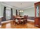 Traditional dining room featuring hardwood floors, elegant trim, and a classic chandelier at 103 Glenholden Ln, Mooresville, NC 28115