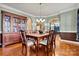 Formal dining room with hardwood floors, crown molding, and decorative display cabinet at 103 Glenholden Ln, Mooresville, NC 28115