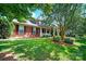 Charming two-story brick home with well-maintained landscaping and a manicured lawn at 103 Glenholden Ln, Mooresville, NC 28115
