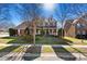 Charming two-story brick home with a welcoming front porch and well-manicured lawn at 103 Glenholden Ln, Mooresville, NC 28115