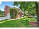 Beautiful brick home featuring a lush green lawn and mature trees at 103 Glenholden Ln, Mooresville, NC 28115