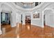 Expansive foyer featuring hardwood floors, columns, staircase, and views of dining and living areas at 103 Glenholden Ln, Mooresville, NC 28115