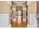 Grand foyer with elegant arches, columns, hardwood floors, and an open view to other living spaces at 103 Glenholden Ln, Mooresville, NC 28115