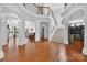 Grand foyer showcasing hardwood floors, staircase, balcony, and open floor plan with natural light at 103 Glenholden Ln, Mooresville, NC 28115