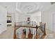 Grand foyer boasts an impressive staircase, wrought iron railings, and coffered ceiling at 103 Glenholden Ln, Mooresville, NC 28115