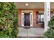 Close-up of the front door and porch, with brick accents and decorative shrubbery at 103 Glenholden Ln, Mooresville, NC 28115