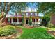 Charming brick two-story home featuring a welcoming front porch and beautifully landscaped front yard at 103 Glenholden Ln, Mooresville, NC 28115