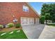 Spacious garage with a clean concrete driveway and lush landscaping at 103 Glenholden Ln, Mooresville, NC 28115
