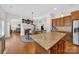 Open kitchen with island and granite counters seamlessly connects to the living and dining spaces at 103 Glenholden Ln, Mooresville, NC 28115