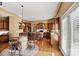 Gourmet kitchen featuring stainless steel appliances, granite countertops, and a stylish dining area with a wine-barrel table at 103 Glenholden Ln, Mooresville, NC 28115