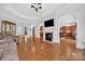 Large living room featuring elegant arches, a fireplace, and hardwood floors at 103 Glenholden Ln, Mooresville, NC 28115
