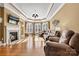 Inviting living room with a fireplace, hardwood floors, and comfortable seating under tray ceilings at 103 Glenholden Ln, Mooresville, NC 28115