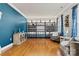 Elegant living room showcasing hardwood floors, blue accent wall, and custom wine rack at 103 Glenholden Ln, Mooresville, NC 28115