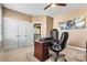 Well-lit office space features neutral walls, a ceiling fan, and a large desk and chair at 103 Glenholden Ln, Mooresville, NC 28115