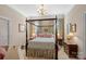 Charming bedroom with four-poster bed and floral curtains at 104 Lazenby Dr, Fort Mill, SC 29715