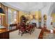 Formal dining room with hardwood floors, large windows, and fireplace at 104 Lazenby Dr, Fort Mill, SC 29715