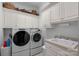 Laundry room with washer, dryer, and ample cabinet space at 104 Lazenby Dr, Fort Mill, SC 29715