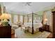 Large main bedroom with a four-poster bed and ample natural light at 104 Lazenby Dr, Fort Mill, SC 29715