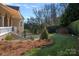 Stone patio with lush landscaping and a retractable awning at 104 Lazenby Dr, Fort Mill, SC 29715