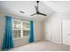 Spacious bedroom with ceiling fan and teal curtains at 10841 Twisted Bark Ln, Charlotte, NC 28213