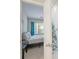 Bright bedroom with teal curtains and en-suite bathroom at 10841 Twisted Bark Ln, Charlotte, NC 28213