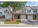 Inviting townhome exterior with brick and vinyl siding, two-car garage, and landscaping at 10841 Twisted Bark Ln, Charlotte, NC 28213