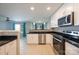 Modern kitchen features white cabinets, black countertops, and stainless steel appliances at 10841 Twisted Bark Ln, Charlotte, NC 28213