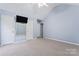 Bright bedroom featuring carpet, double closets, and a wall-mounted TV at 109 Copes Ct, York, SC 29732