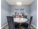 Charming dining area with a round white table and four gray velvet chairs at 109 Copes Ct, York, SC 29732