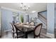 Spacious dining room with a dark wood table and six beige chairs, located near staircase at 109 Copes Ct, York, SC 29732