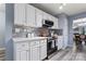 Modern kitchen featuring white cabinets, stainless steel appliances, and stylish backsplash at 109 Copes Ct, York, SC 29732