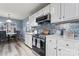 Modern kitchen with white cabinets, stainless steel appliances, and quartz countertops at 109 Copes Ct, York, SC 29732