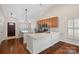 Eat-in kitchen with granite island, hardwood floors, and modern cabinetry at 109 Washburn Range Dr, Mooresville, NC 28115