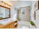 Bathroom with a wood vanity, a bathtub, and a modern shower at 11270 Widenhouse Rd, Midland, NC 28107